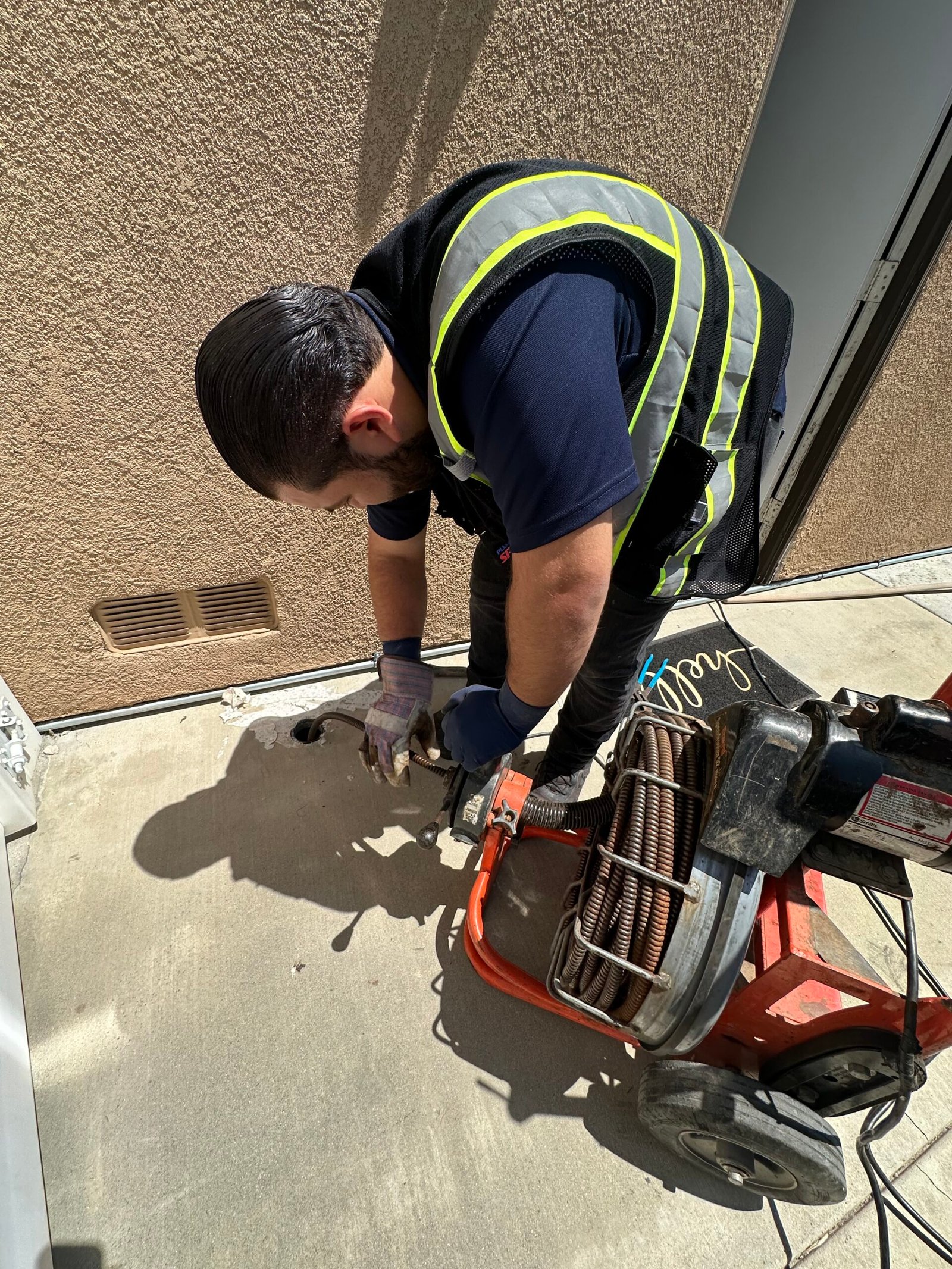 Professional drain cleaning service clearing a clogged kitchen sink in Southern California